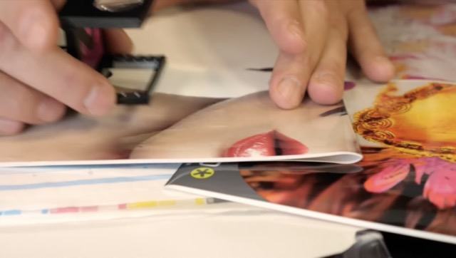 Photo of Médialliance employee inspecting label sheets